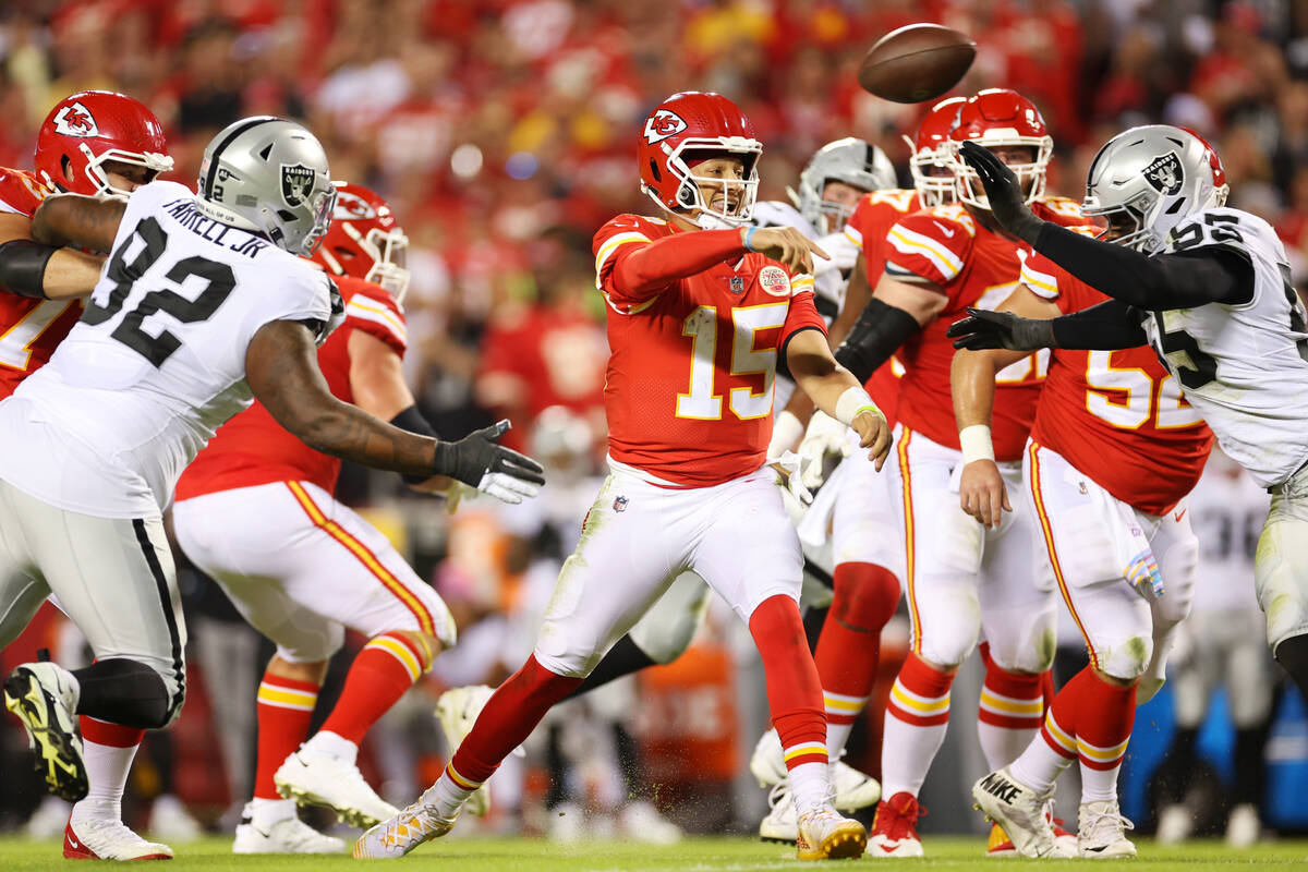 Kansas City Chiefs quarterback Patrick Mahomes (15) makes a pass under pressure during the firs ...