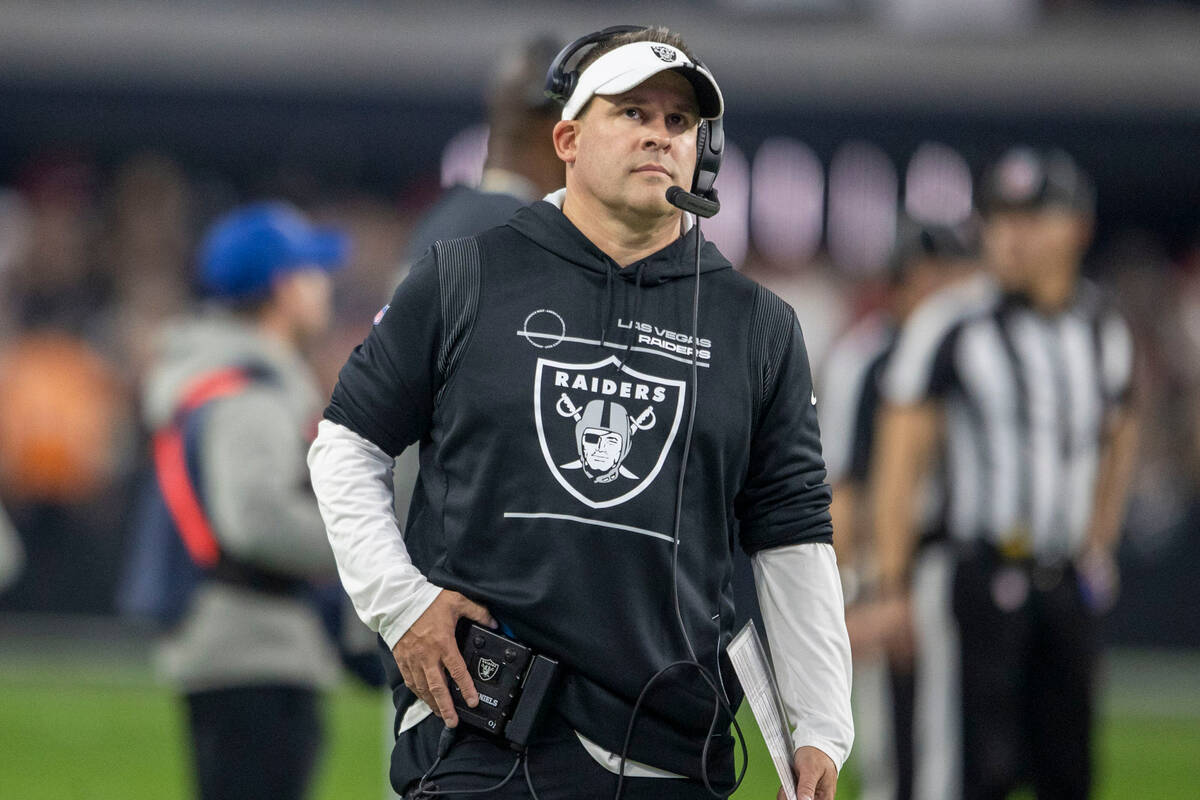 Raiders head coach Josh McDaniels looks to a replay monitor during the second half of an NFL ga ...