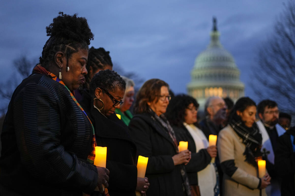 The Rev. Dr. Cassandra Gould, left, gathers with other Christian leaders for a prayer vigil to ...