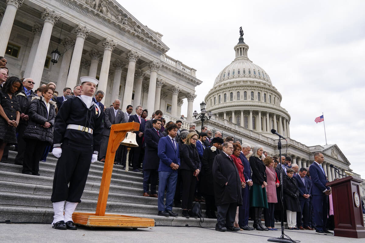 House Democratic leader Hakeem Jeffries, D-N.Y., right, members of Congress, and family of fall ...