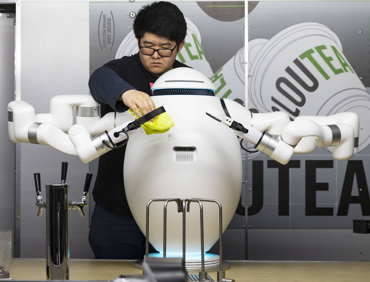 Chad Wu of Richtech Robotics, cleans a boba tea maker robot during CES 2023 at the Las Vegas Co ...
