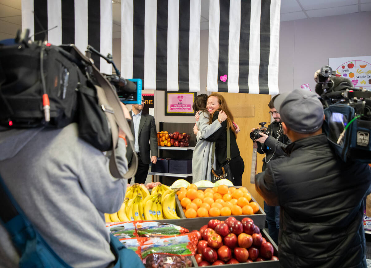 Brooke Neubauer, left, founder and CEO of The Just One Project, hugs Dorian Stonebarger, chief ...