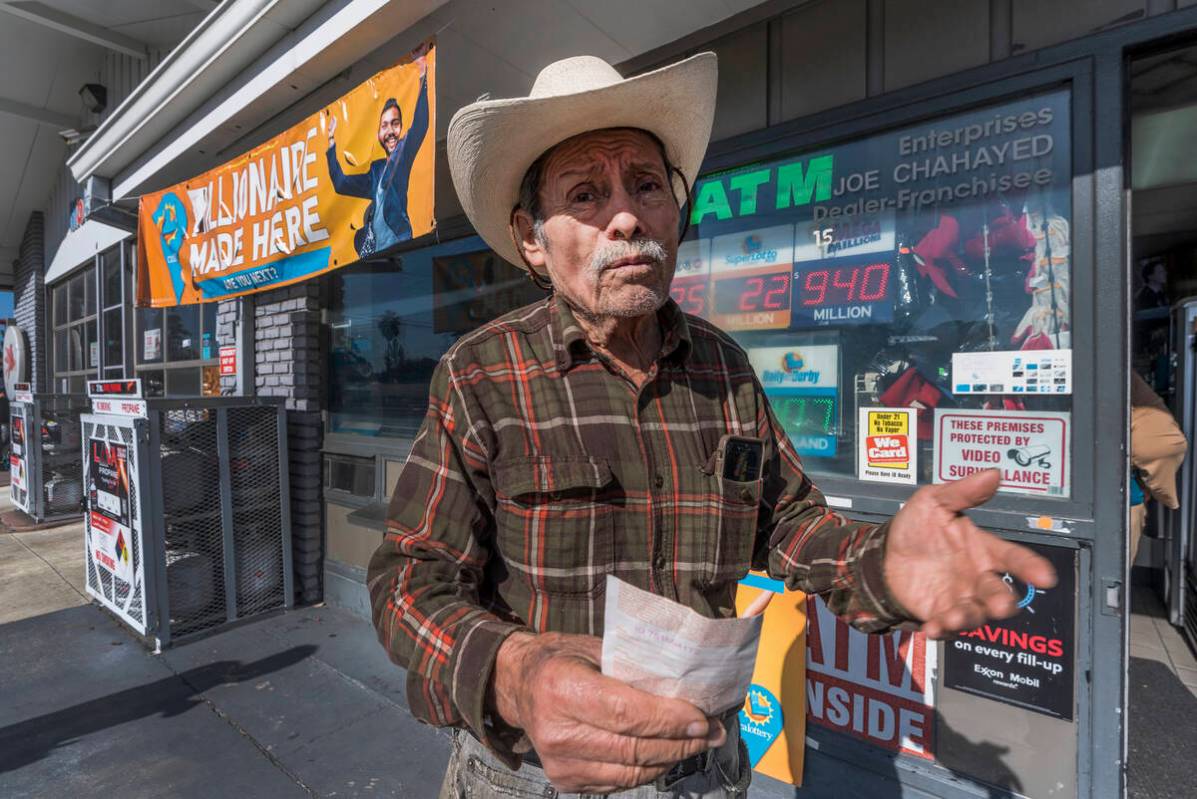 Roberto Ramirez, 77, from Guadalajara, Mexico holds a SuperLotto Plus ticket at the gas station ...