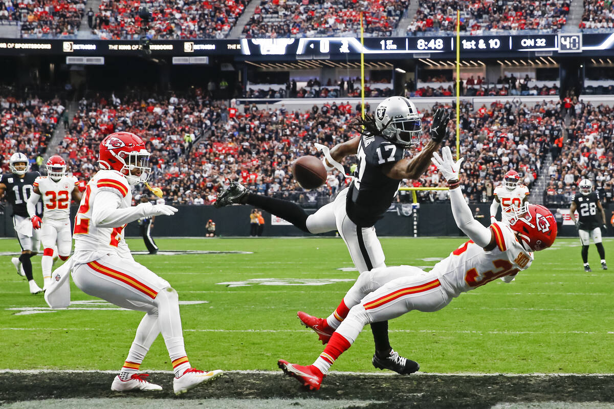 Raiders wide receiver Davante Adams (17) comes up short on a touchdown pass under pressure from ...