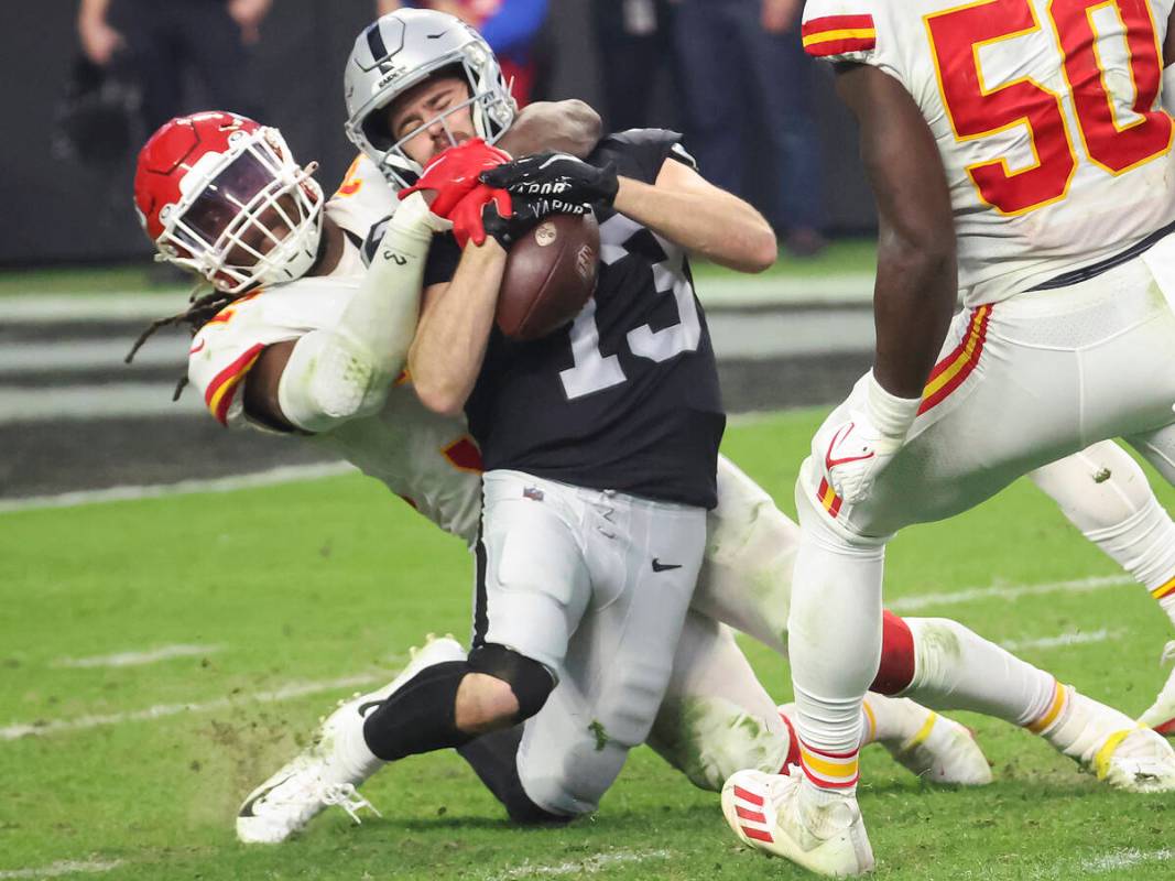 Kansas City Chiefs linebacker Nick Bolton (32) tackles Raiders wide receiver Hunter Renfrow (13 ...