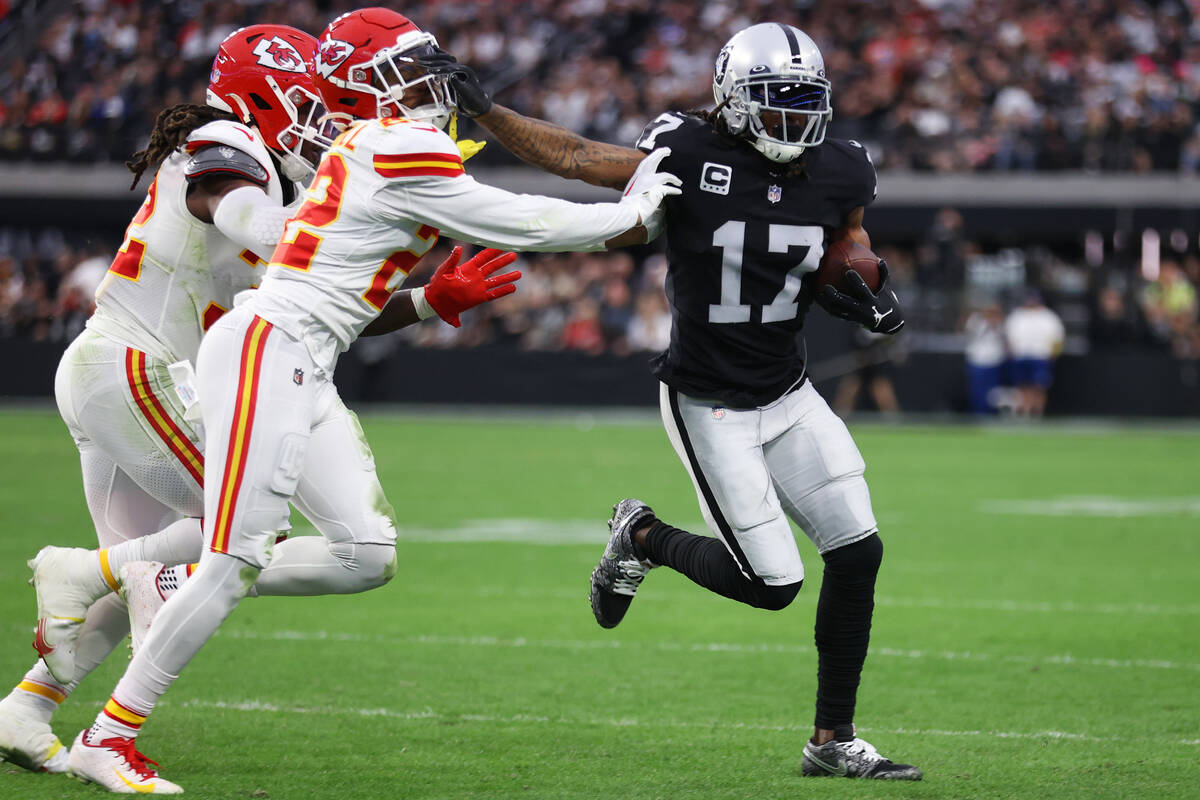 Las Vegas Raiders wide receiver Davante Adams (17) stiff arms Kansas City Chiefs safety Juan Th ...