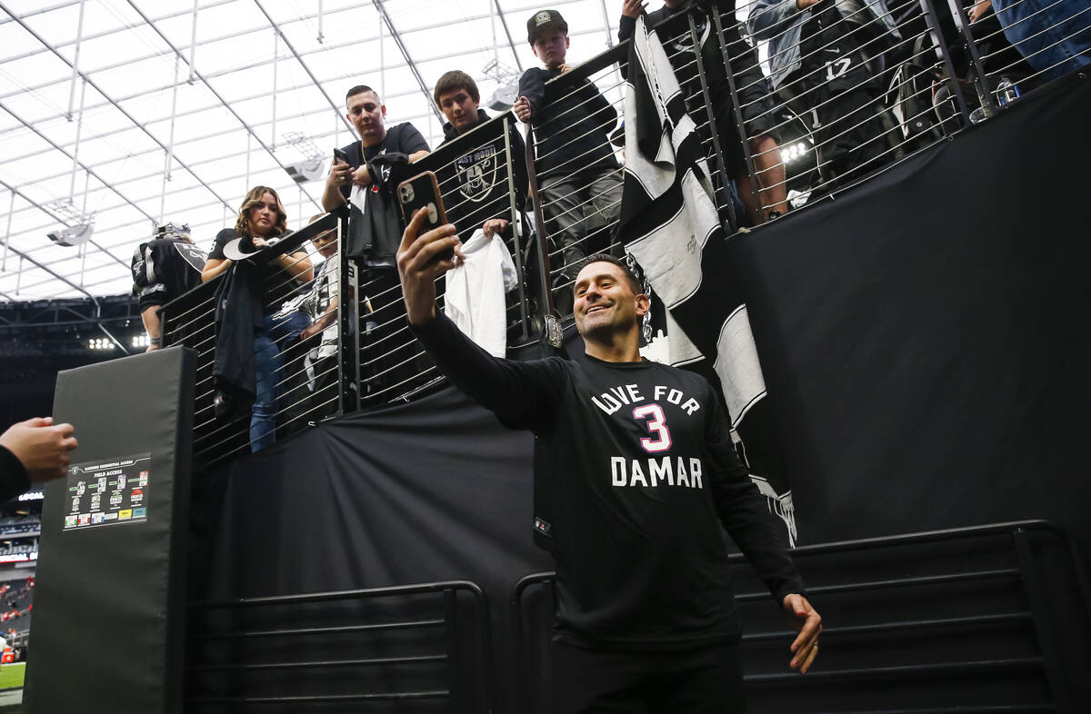 Raiders general manager Dave Ziegler takes photos with fans before an NFL game at Allegiant Sta ...