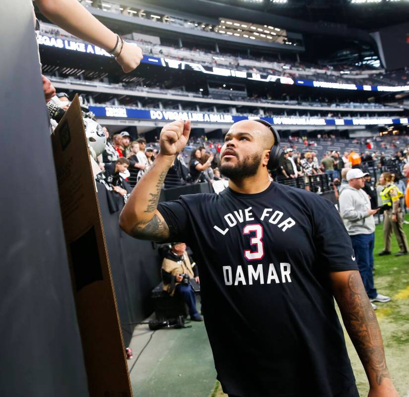 Raiders offensive lineman Jermaine Eluemunor greets fans before an NFL game at Allegiant Stadiu ...