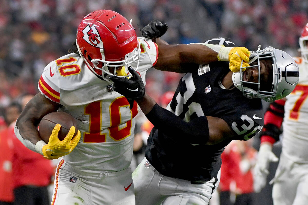 Kansas City Chiefs running back Isiah Pacheco (10) struggles for yardage as Las Vegas Raiders s ...