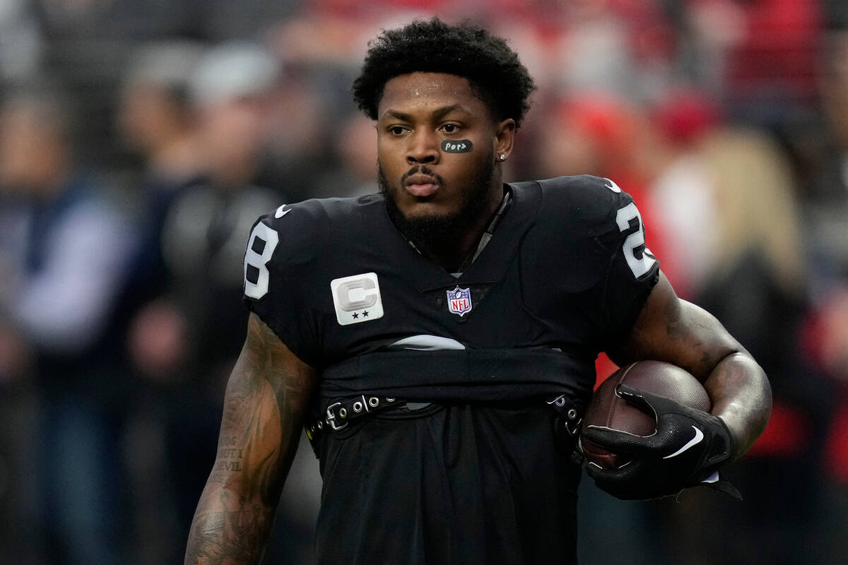 Las Vegas Raiders running back Josh Jacobs warms up before the start of an NFL football game be ...