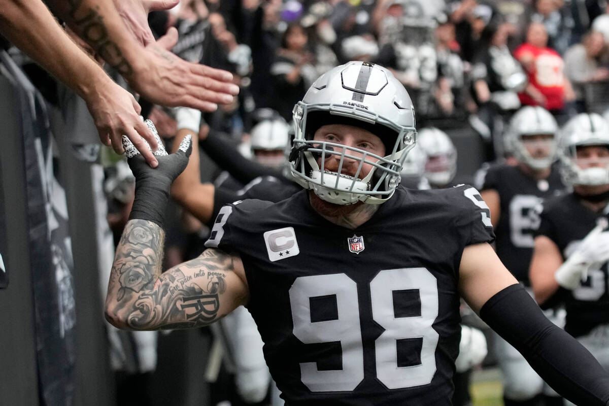 Las Vegas Raiders defensive end Maxx Crosby greets fans before the start of an NFL football gam ...