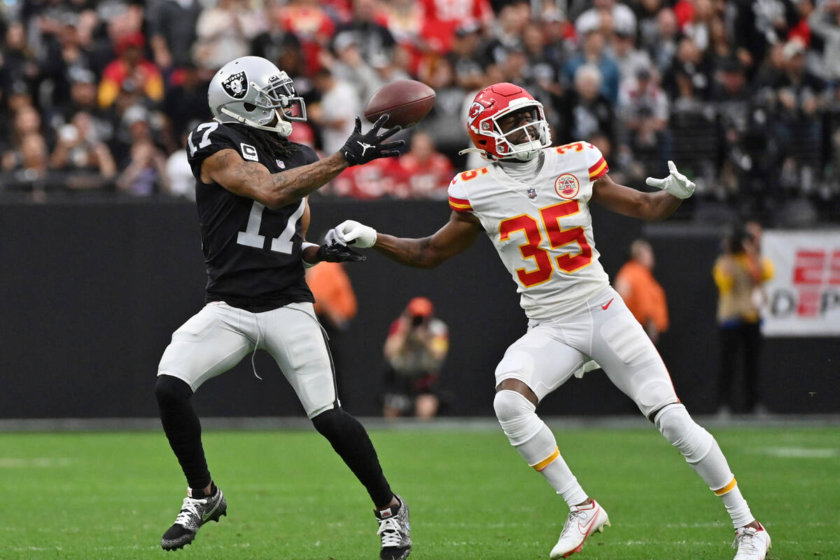 Las Vegas Raiders wide receiver Davante Adams (17) catches a pass as Kansas City Chiefs cornerb ...