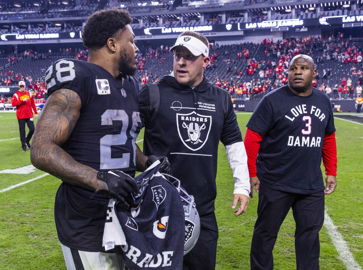 Raiders running back Josh Jacobs (28) and Head Coach Josh Jacobs talk on the way off the field ...