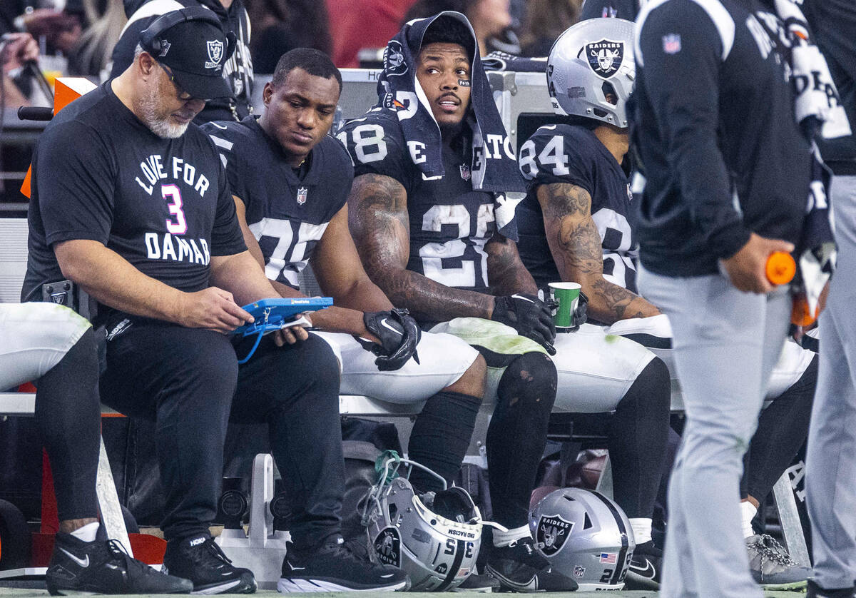 Raiders running back Josh Jacobs (28) sits on the bench during a change of possession against t ...