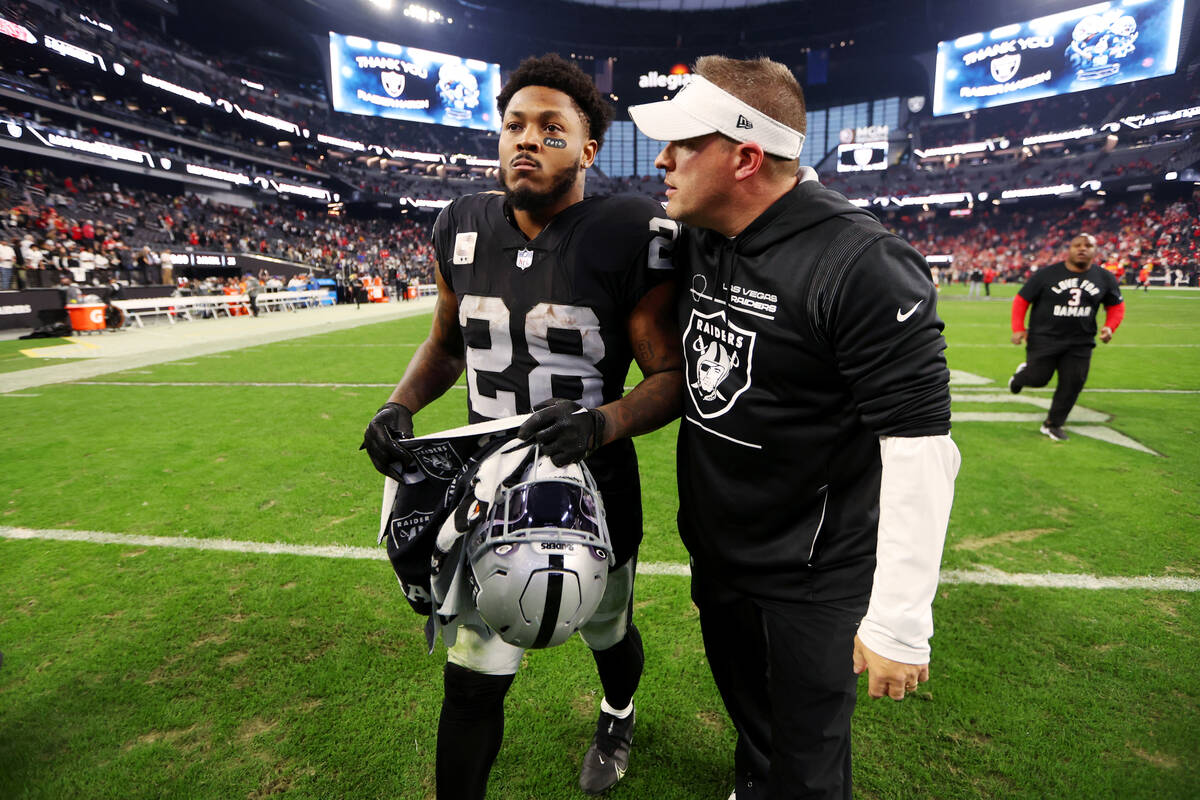 Las Vegas Raiders cornerback Anthony Averett (29) talks to head coach Josh McDaniels at the end ...