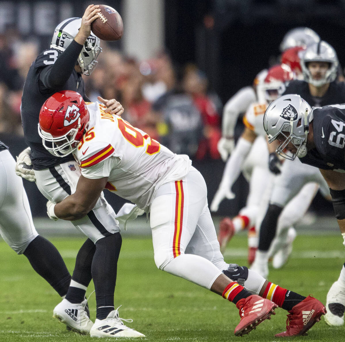 Kansas City Chiefs defensive tackle Chris Jones (95) sacks Raiders quarterback Jarrett Stidham ...