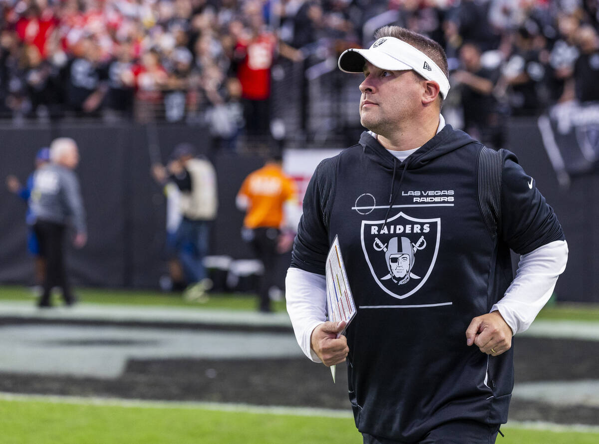 Raiders Head Coach Josh McDaniels runs onto the field to face the Kansas City Chiefs during the ...