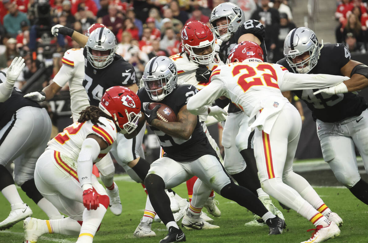 Raiders running back Josh Jacobs (28) runs the ball against the Kansas City Chiefs during the f ...