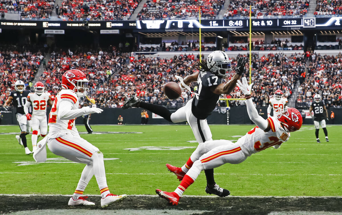 Raiders wide receiver Davante Adams (17) comes up short on a touchdown pass under pressure from ...