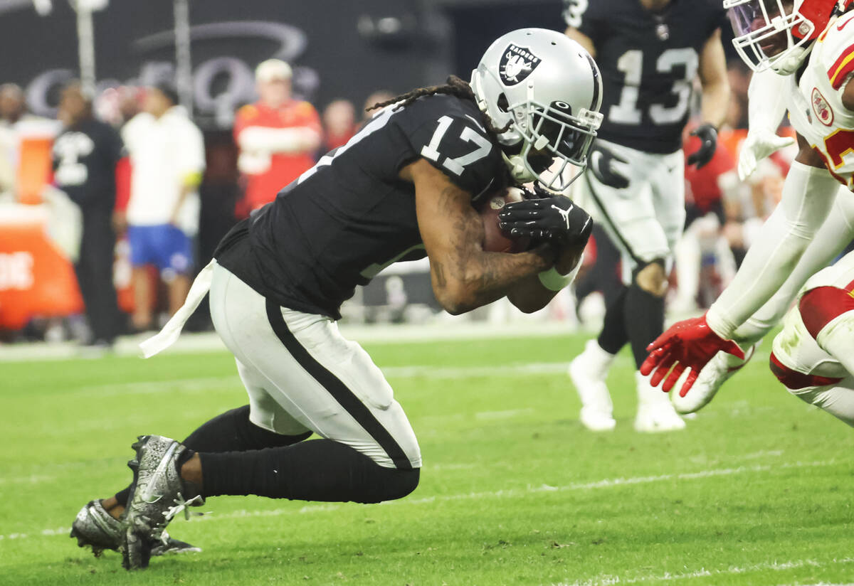 Raiders wide receiver Davante Adams (17) carries the ball against the Kansas City Chiefs during ...