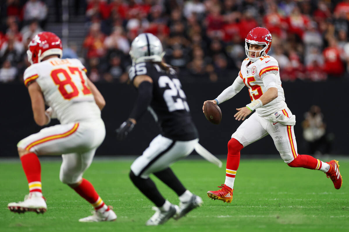 Kansas City Chiefs quarterback Patrick Mahomes (15) runs the ball as his teammate tight end Tra ...