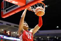 UNLV's David Muoka dunks against New Mexico during the first half of an NCAA college basketball ...