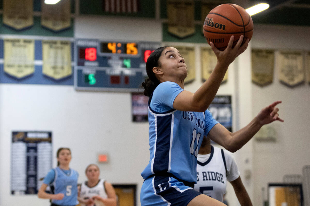 Centennial’s Danae Powell (11) drives toward the hoop for a layup during a girls high sc ...