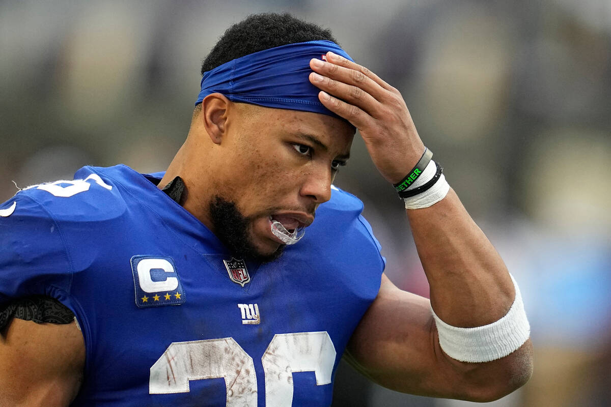 New York Giants running back Saquon Barkley (26) walks off the field at halftime of an NFL foot ...