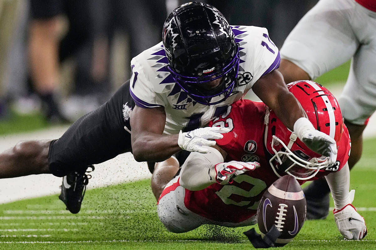 TCU wide receiver Derius Davis (11) fumbles the ball against Georgia defensive back Christopher ...