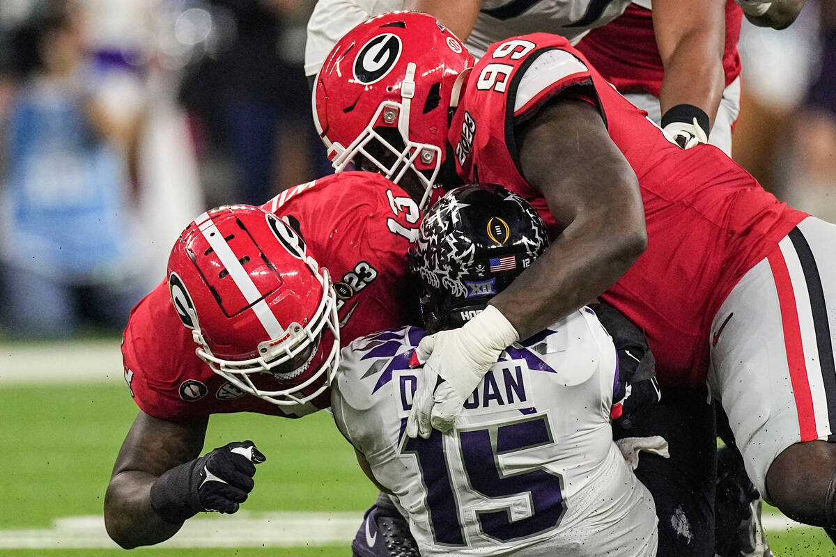 Georgia defensive lineman Bear Alexander (99) and defensive lineman Mykel Williams (13) sack TC ...