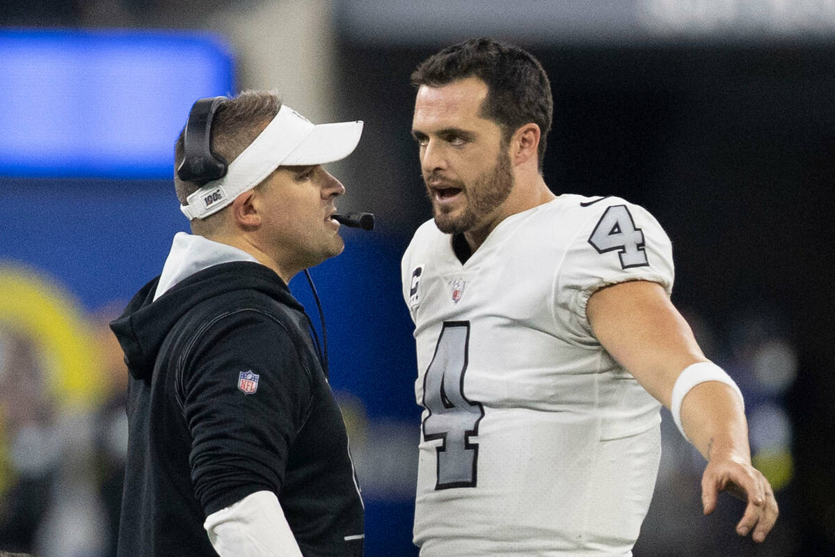 Raiders quarterback Derek Carr (4) and Raiders head coach Josh McDaniels speak during the secon ...