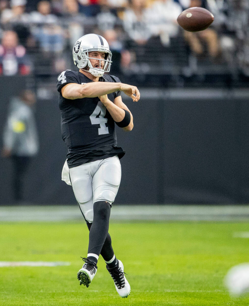 Raiders quarterback Derek Carr (4) throws on the run during the first half of an NFL game at Al ...