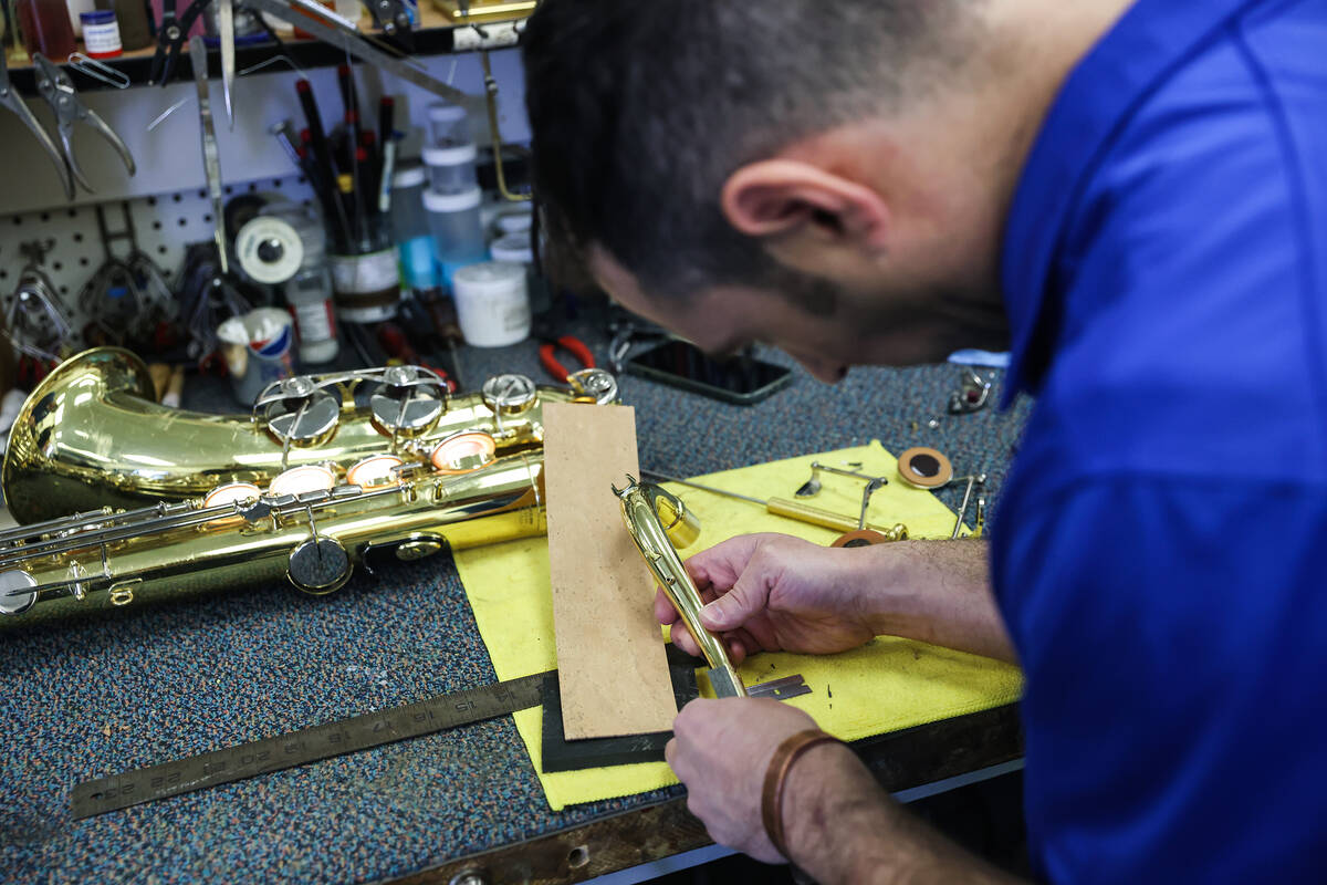 Tim Adelson, a musical instrument repair technician for the Clark County School District, repai ...