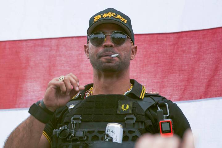 FILE - Proud Boys leader Henry "Enrique" Tarrio wears a hat that says The War Boys du ...