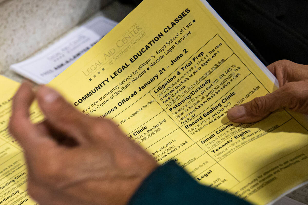 A man picks up informational papers at the Legal Aid Center of Southern Nevada on Tuesday, Jan. ...