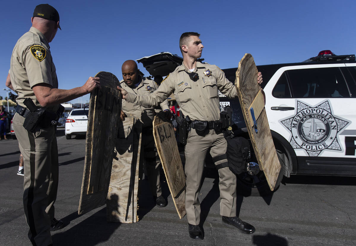 Las Vegas police seize wooden signs they deemed to be a threat during a Juneteenth rally organi ...