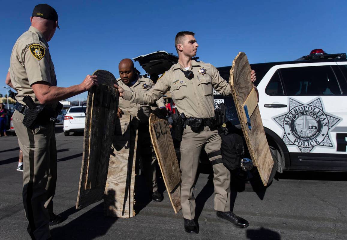 Las Vegas police seize wooden signs they deemed to be a threat during a Juneteenth rally organi ...