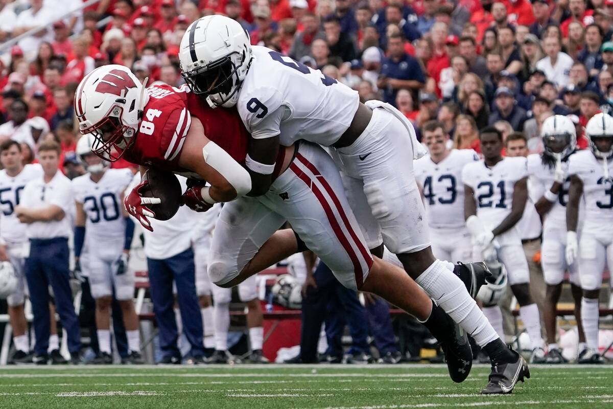 Wisconsin's Jake Ferguson catches a pass in front of Penn State's Joey Porter Jr. during the fi ...