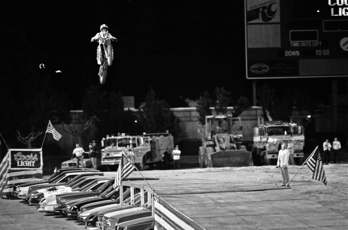 Robbie Knievel jumps his motorcycle 153 1/2 feet over 22 parked cars in May 1987 at Sam Boyd St ...