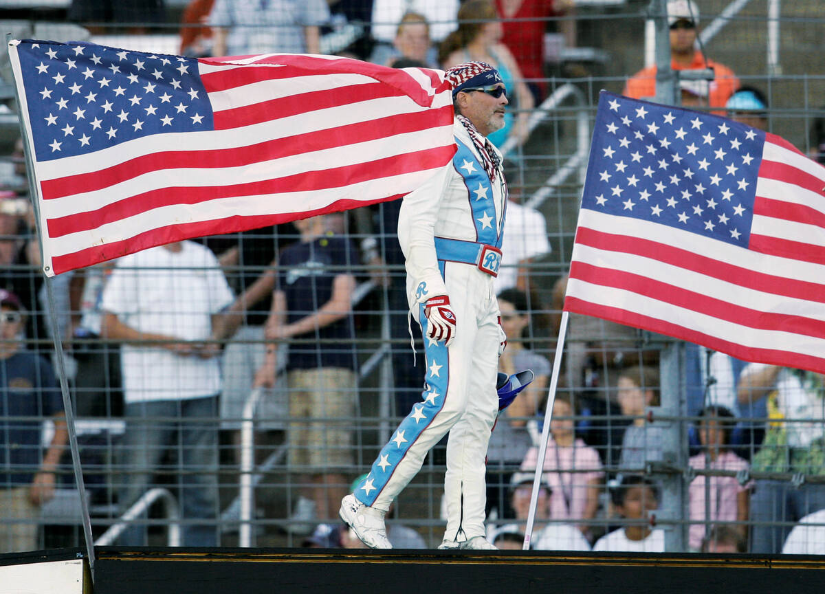 Stunt motorcycle driver Robbie Knievel is introduced on the ramp prior to making his jump over ...