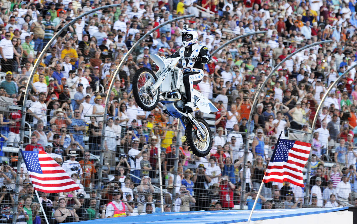 Kaptain Robbie Knievel lands a motorcycle jump before the start of the IRL Firestone 550 auto r ...