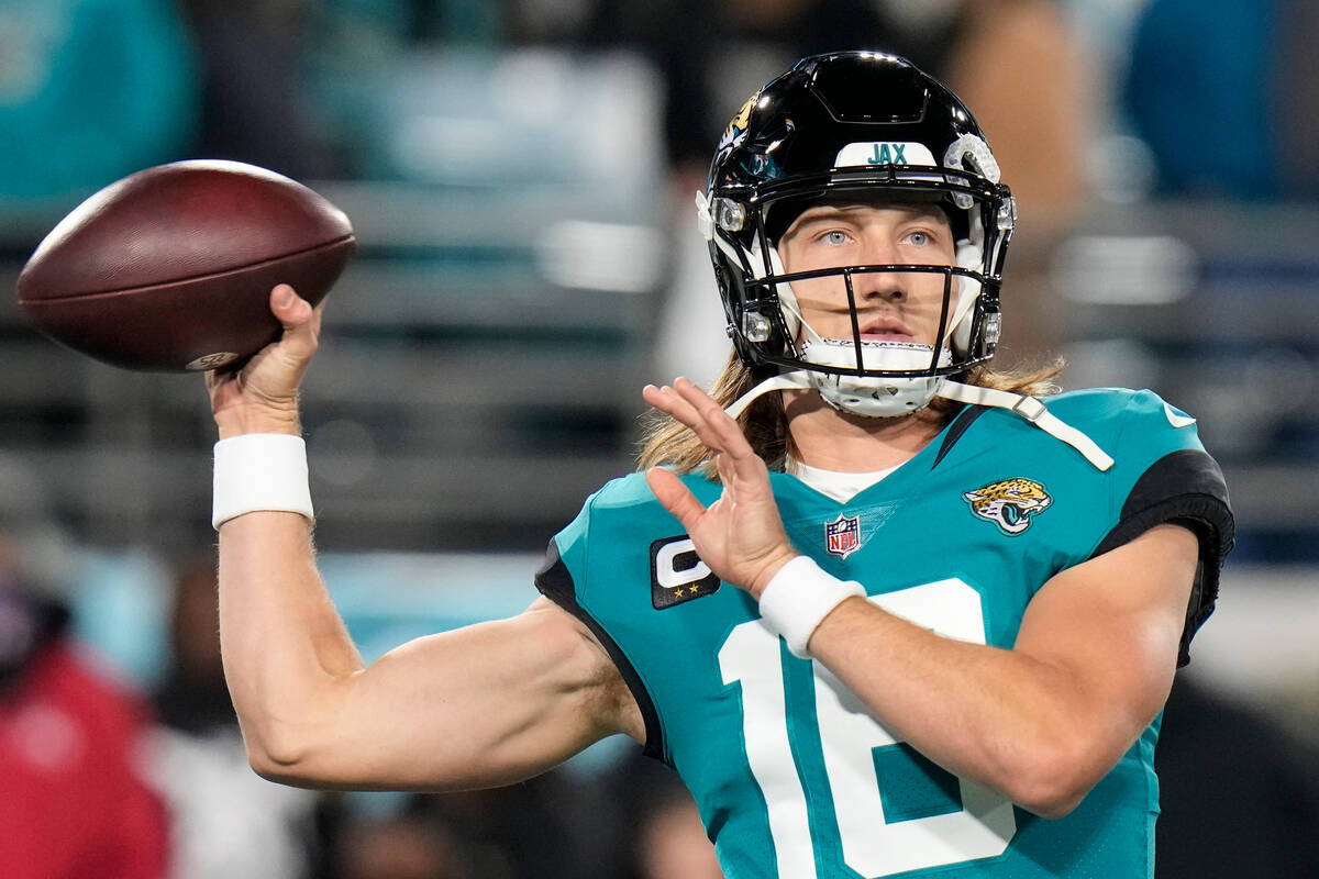 Jacksonville Jaguars quarterback Trevor Lawrence (16) warms up before an NFL wild-card football ...