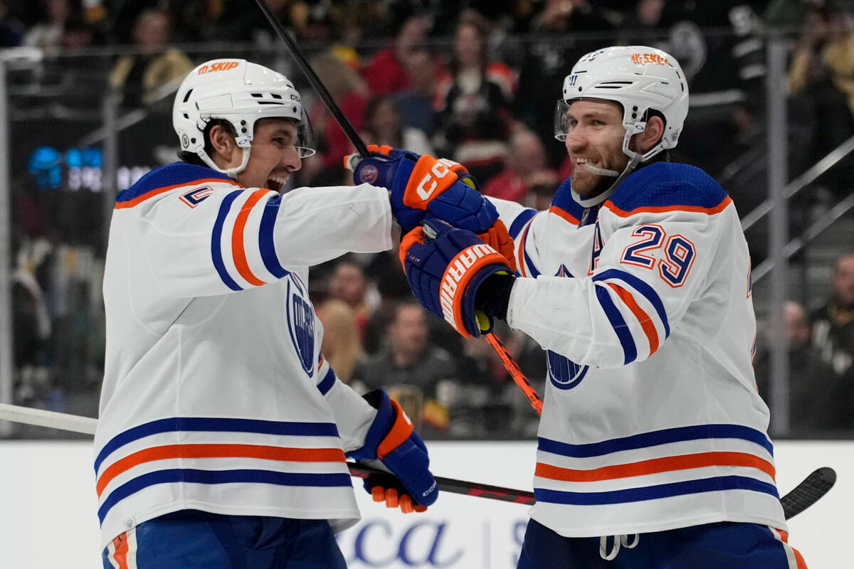 Edmonton Oilers center Leon Draisaitl, right, celebrates after scoring against the Vegas Golden ...