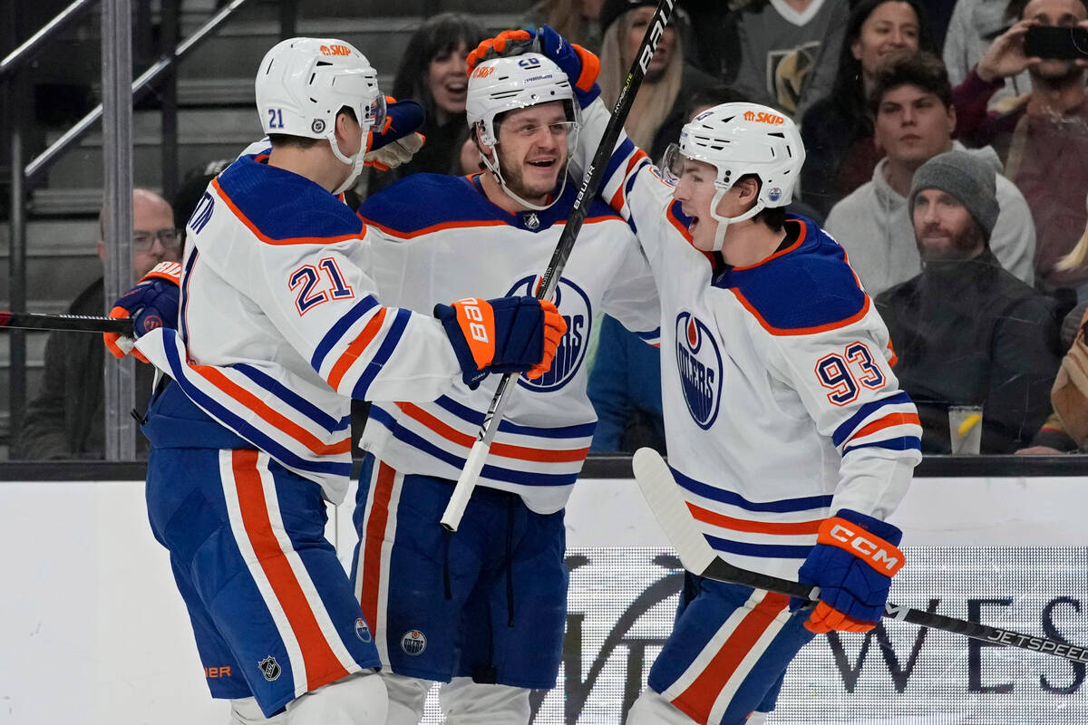 Players celebrate after Edmonton Oilers center Mattias Janmark, center, scored against the Vega ...