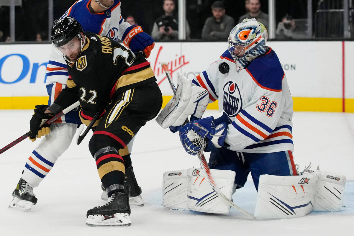 Edmonton Oilers goaltender Jack Campbell (36) blocks a shot beside Vegas Golden Knights center ...