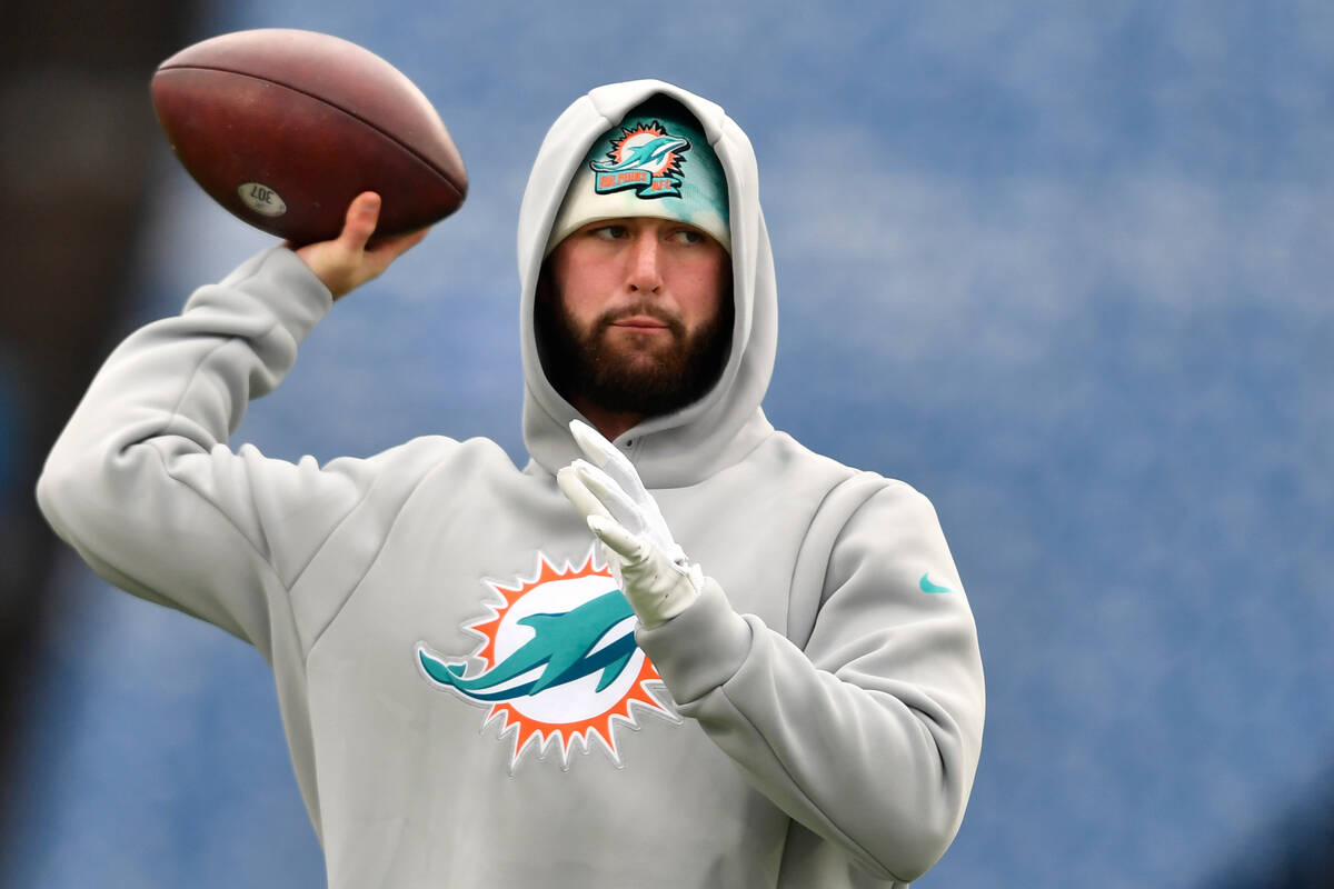 Miami Dolphins quarterback Skylar Thompson warms up prior to an NFL wild-card playoff football ...