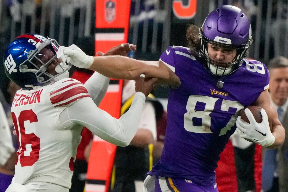 Minnesota Vikings' T.J. Hockenson runs from New York Giants' Tony Jefferson after a reception d ...