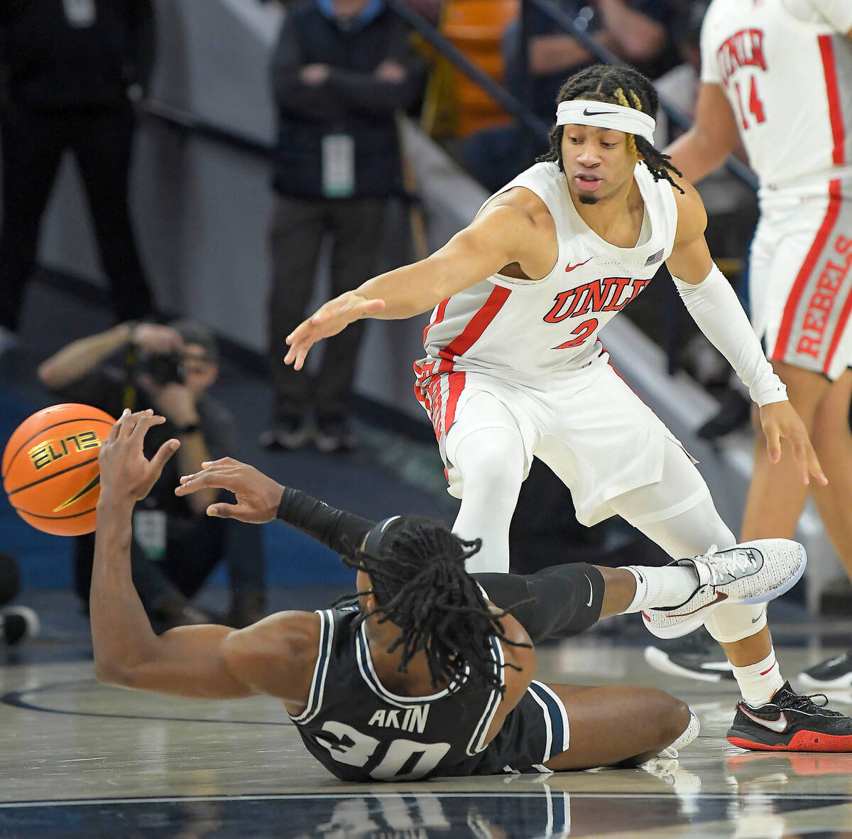 Utah State forward Dan Akin (30) passes the ball as UNLV guard Justin Webster (2) defends durin ...