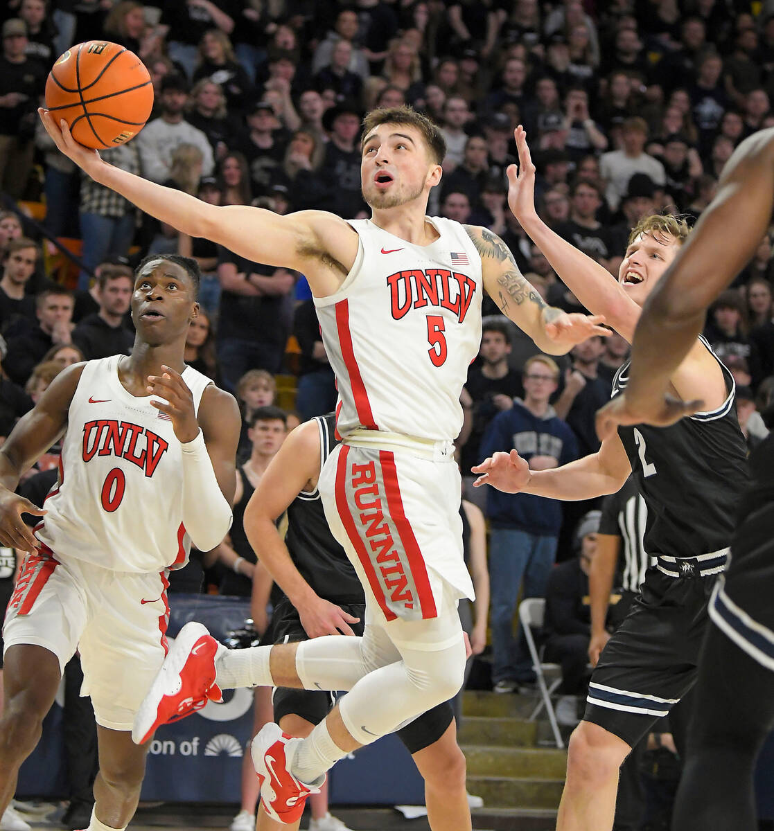 UNLV guard Jordan McCabe (5) shoots the ball as Utah State guard Sean Bairstow (2) defends duri ...