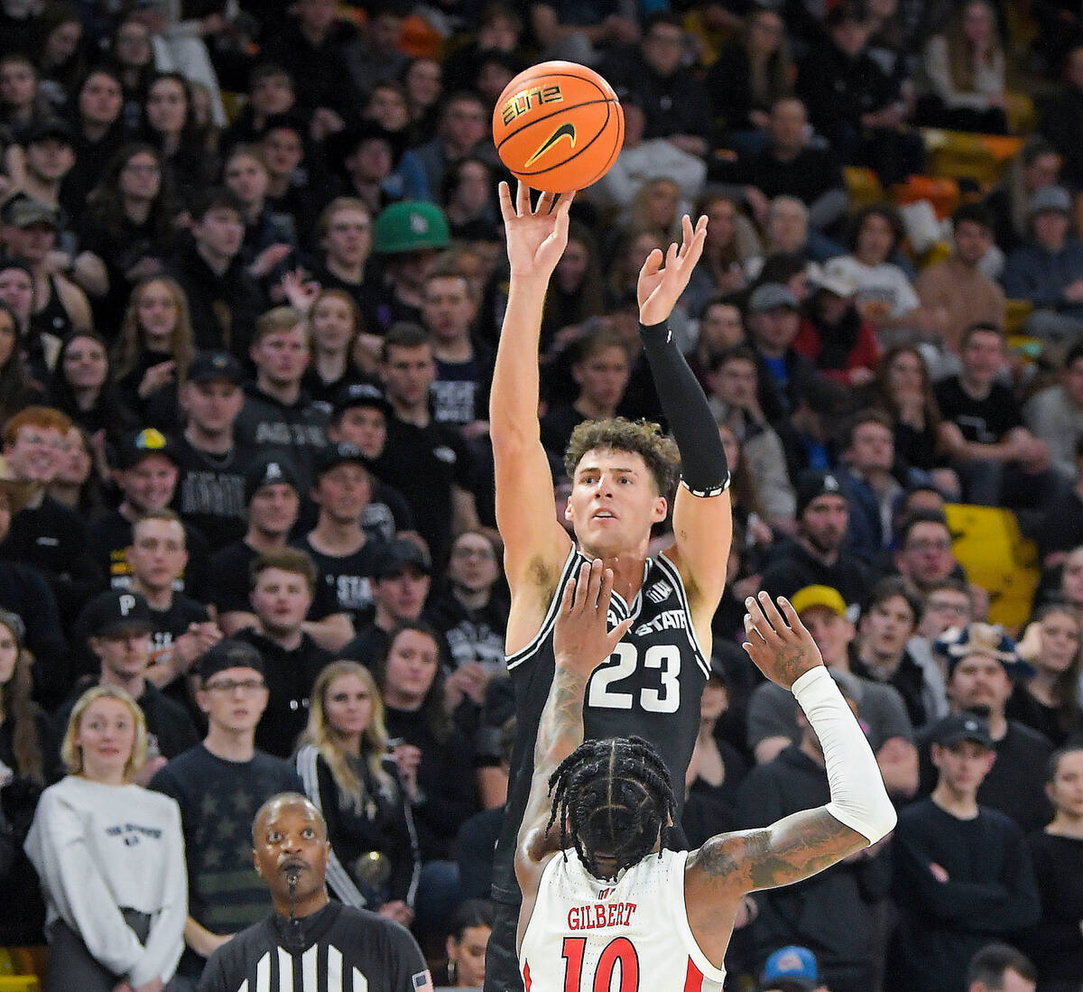 Utah State forward Taylor Funk (23) makes a 3-pointer as UNLV guard Keshon Gilbert (10) defends ...